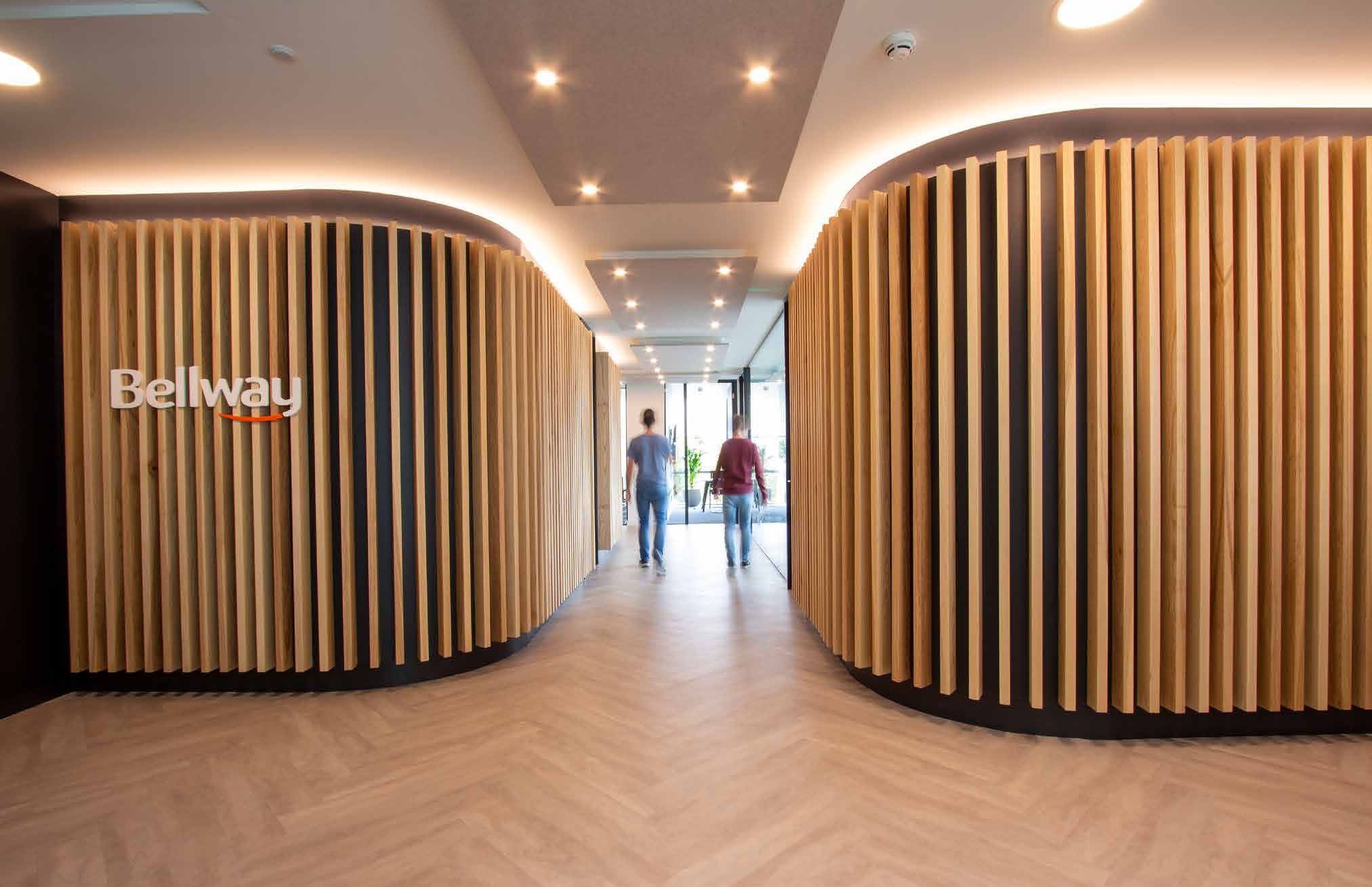 Completed Bellway reception with curved timber fins and a clear central arrival route